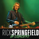 Rick Springfield performing live on stage with guitar under green lighting, with bold text below that reads “Rick Springfield In Concert.”