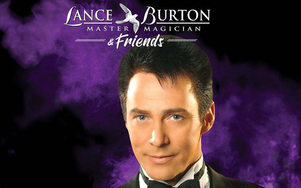 Promotional image for Lance Burton Master Magician & Friends. A portrait of Lance Burton in a tuxedo against a dramatic purple smoke background, with the show title in white text above.