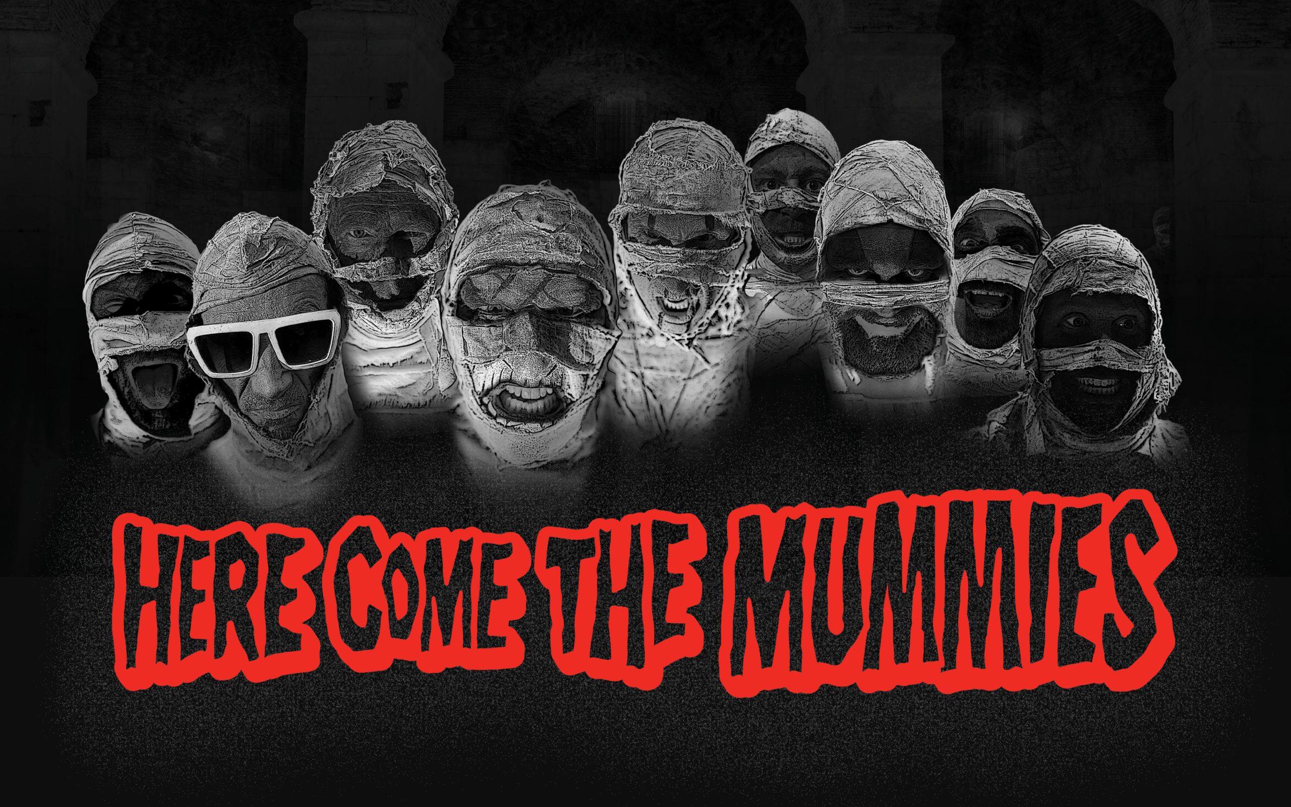 Black and white photo of mummies. Red text reads "Here Come the Mummies."