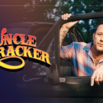 Uncle Kracker posed in an open truck door with an orange and yellow logo reading "Uncle Kracker" to the left.