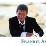 Promotional poster for Frankie Avalon. Pictured is Frankie Avalon posing in a black suit. It reads "Frankie Avalon."